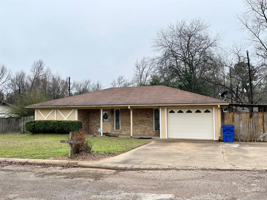 a front view of a house with a garden and garage