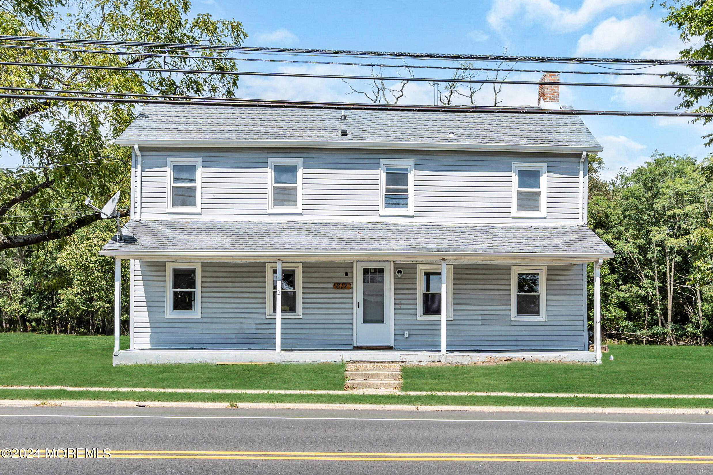 a front view of a house with a garden and garage