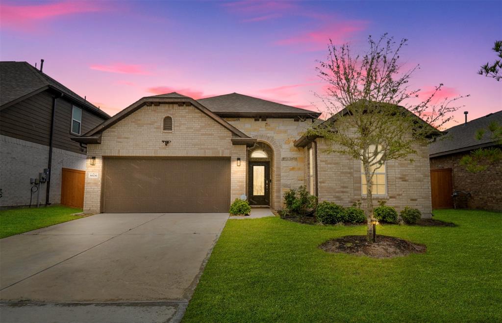 a front view of a house with a yard and garage