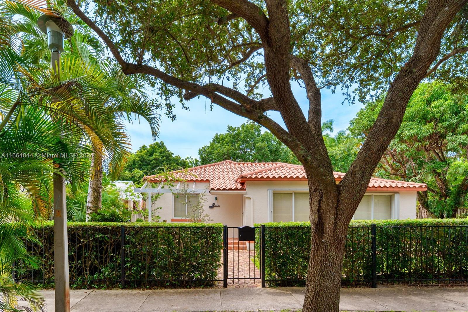 a front view of a house with a tree s