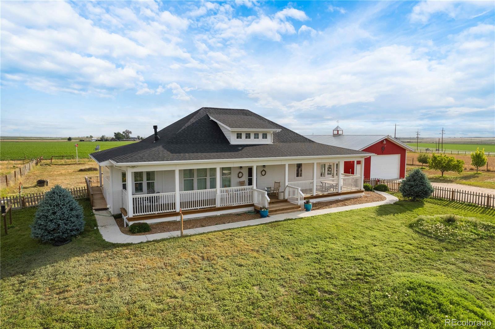 an aerial view of a house with swimming pool lawn chairs and a yard