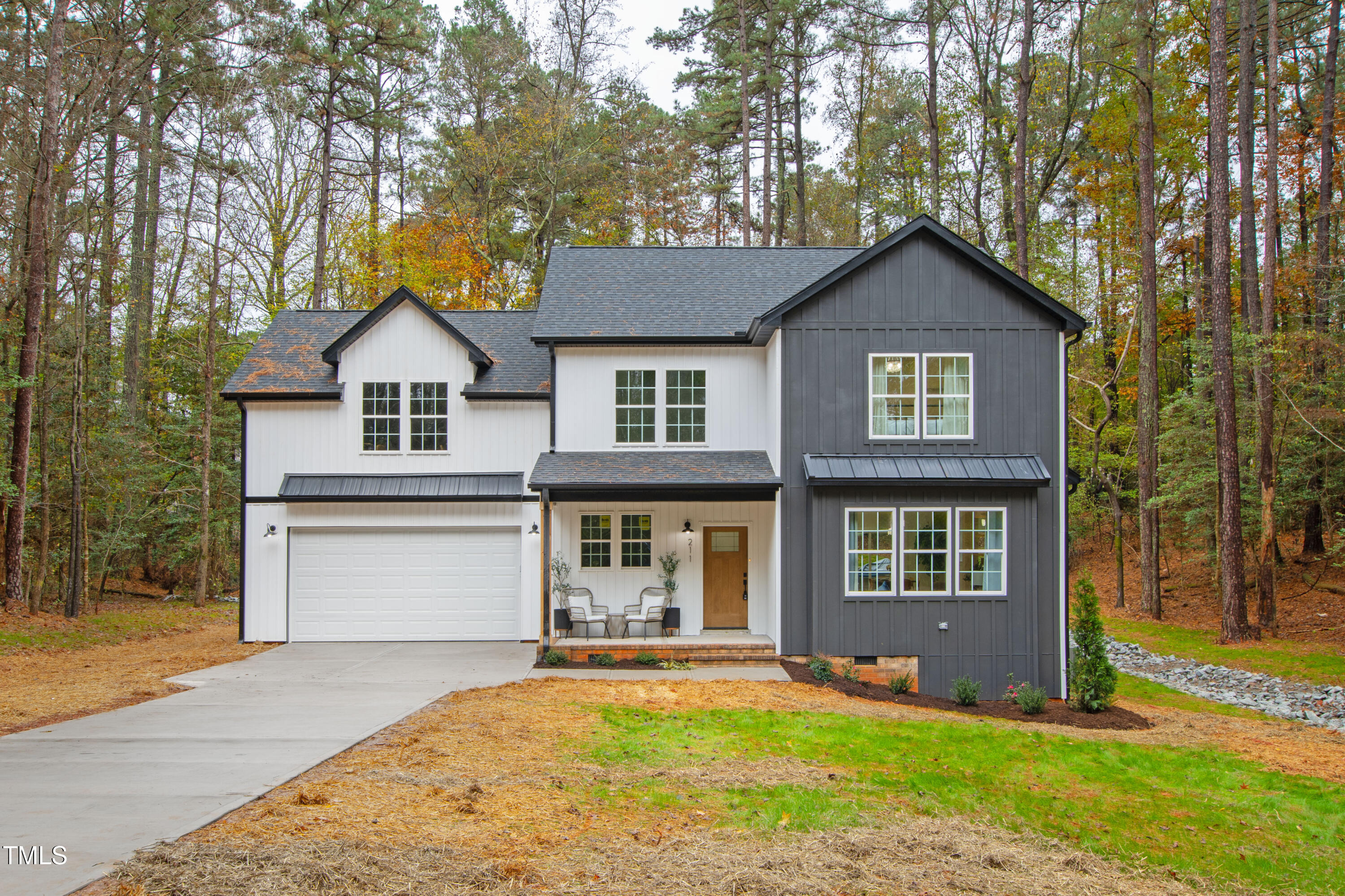 a front view of a house with yard and green space