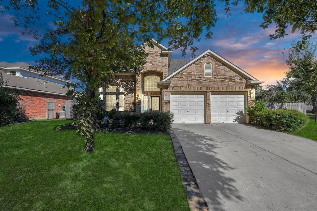 a front view of a house with a yard and garage