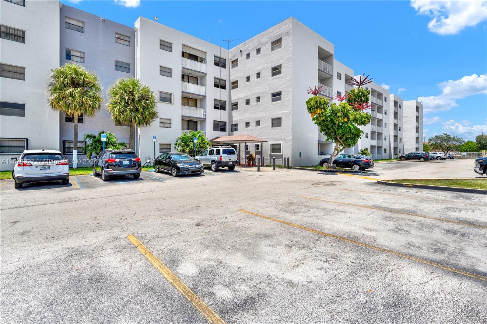 a view of a building with cars parked in front of it