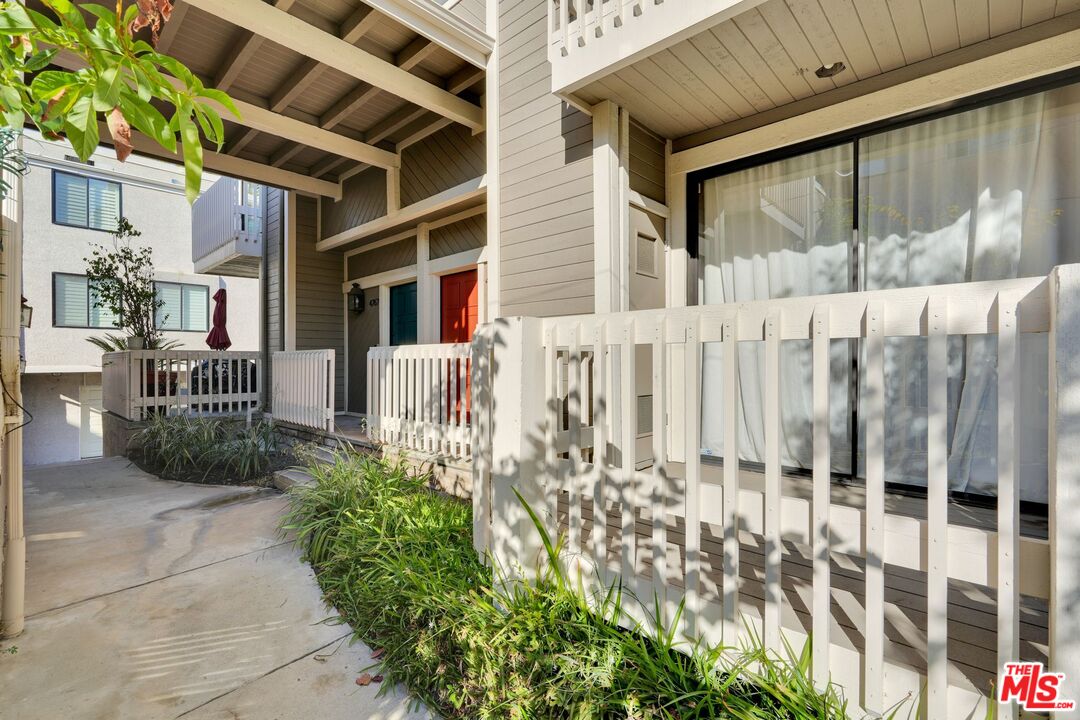 a view of a house with a wooden fence