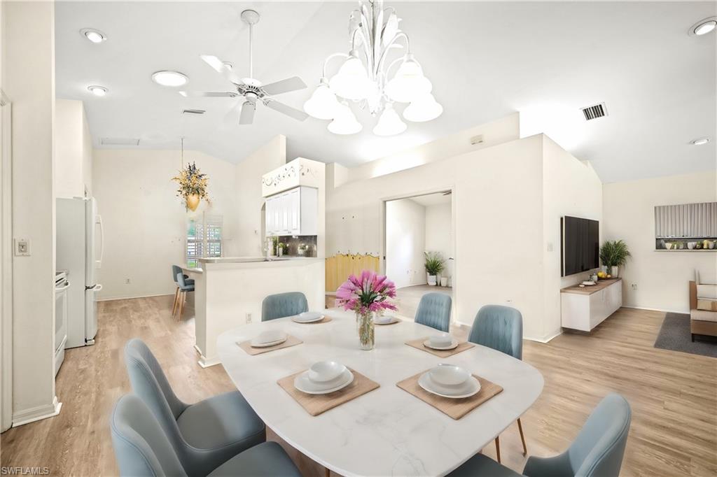 a view of a dining room with furniture and wooden floor