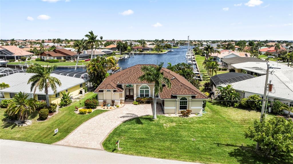 a view of a house with a yard and lake view