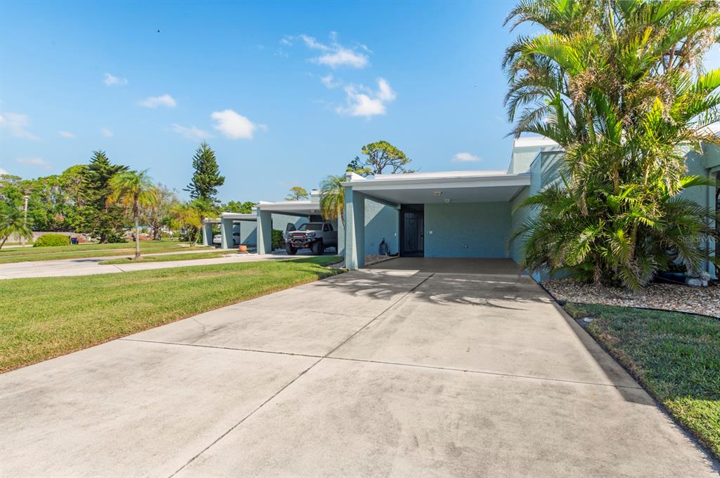 a front view of a house with a yard and trees