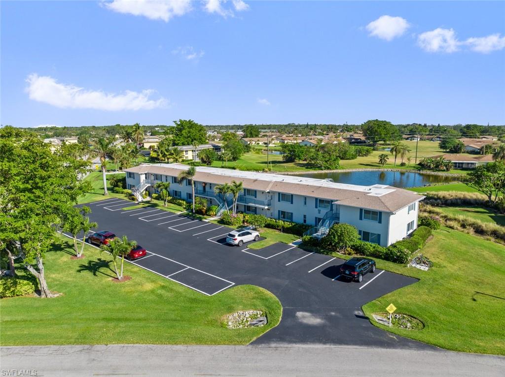 Birds eye view of property with a water view