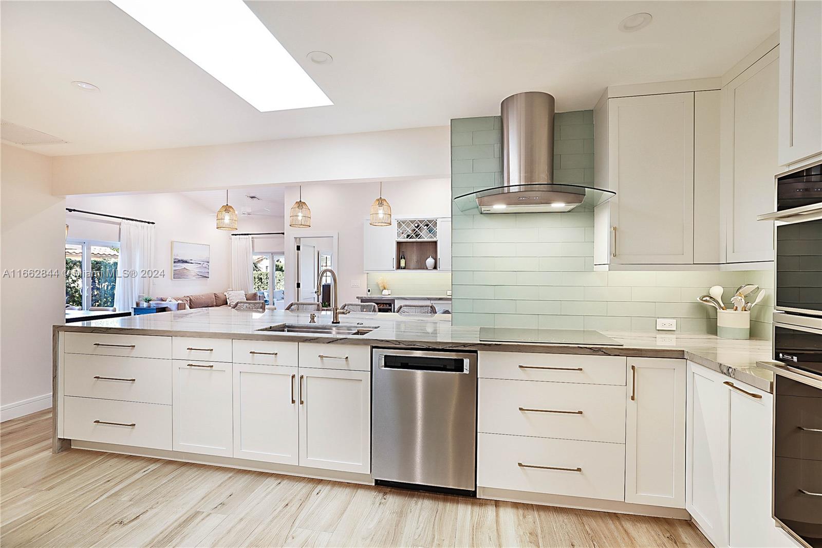 a kitchen with granite countertop white cabinets and stainless steel appliances