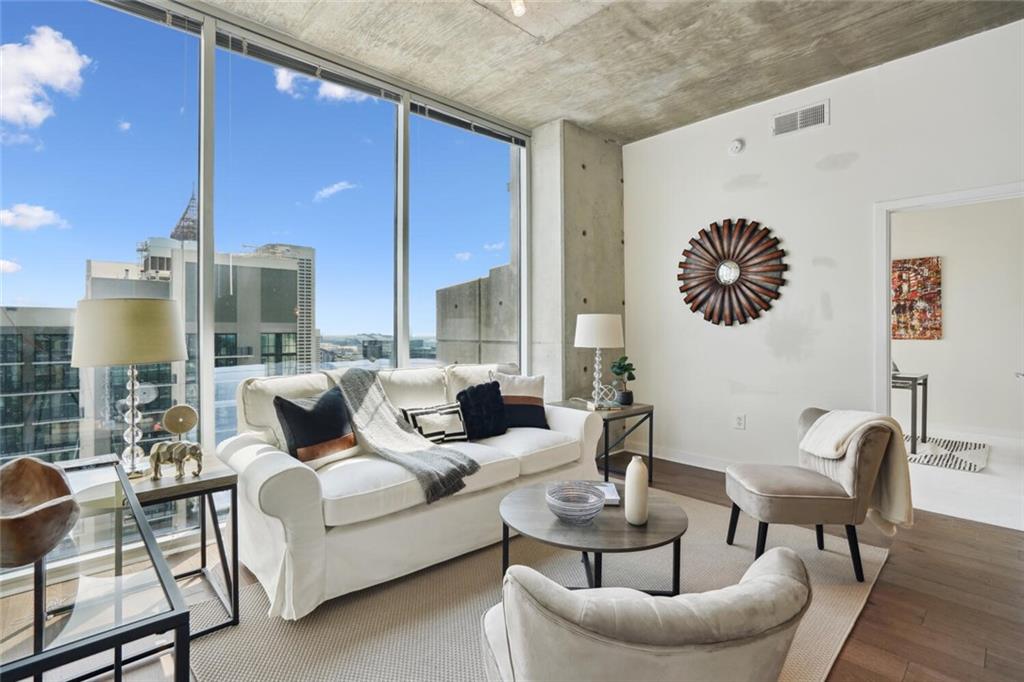 a living room with furniture and a large window