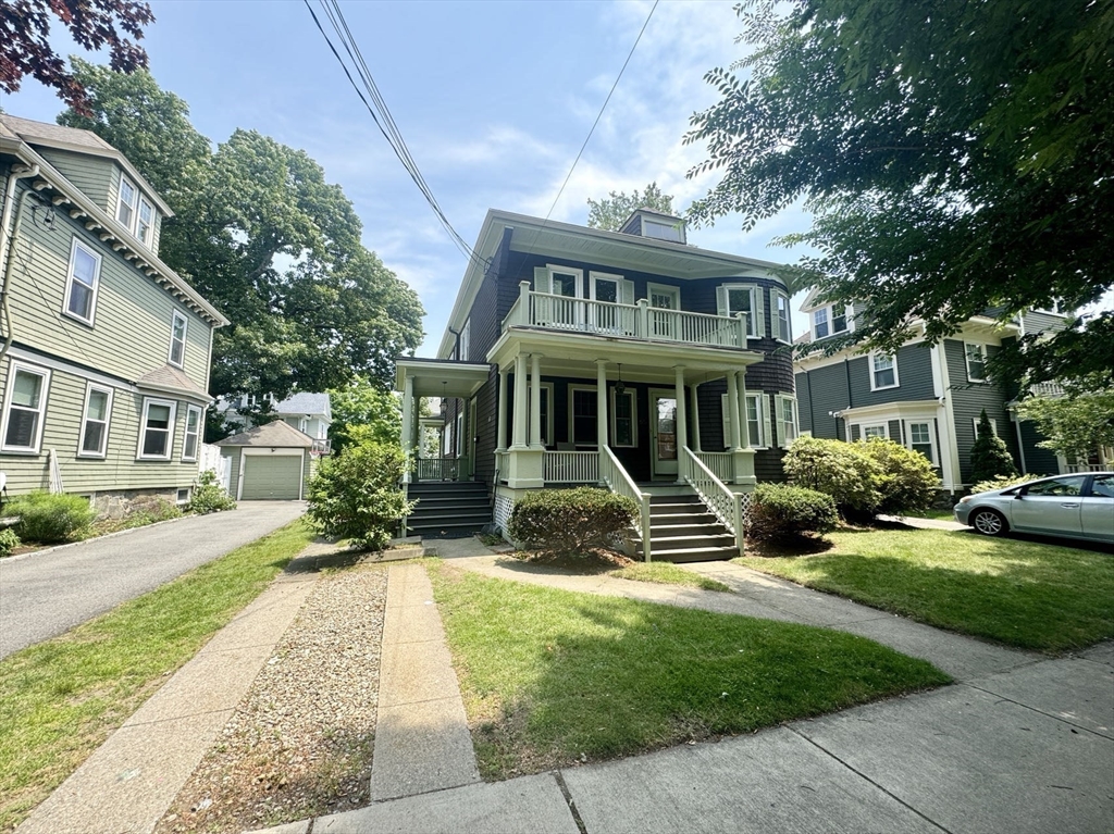 a front view of a house with yard and green space