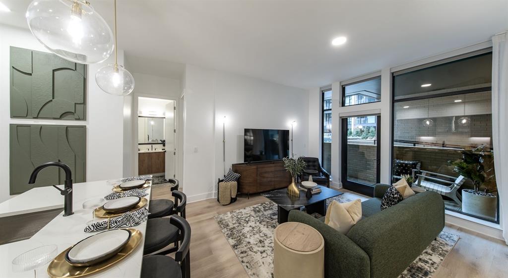 a living room with furniture and wooden floor