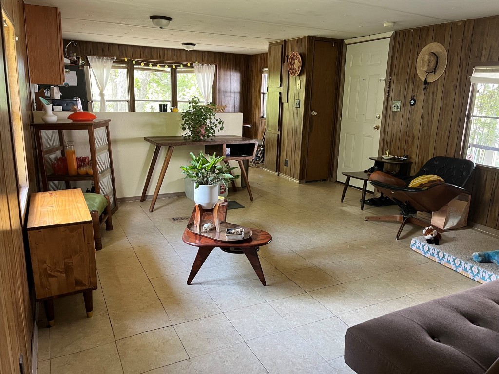 a living room with furniture gym equipment and a window