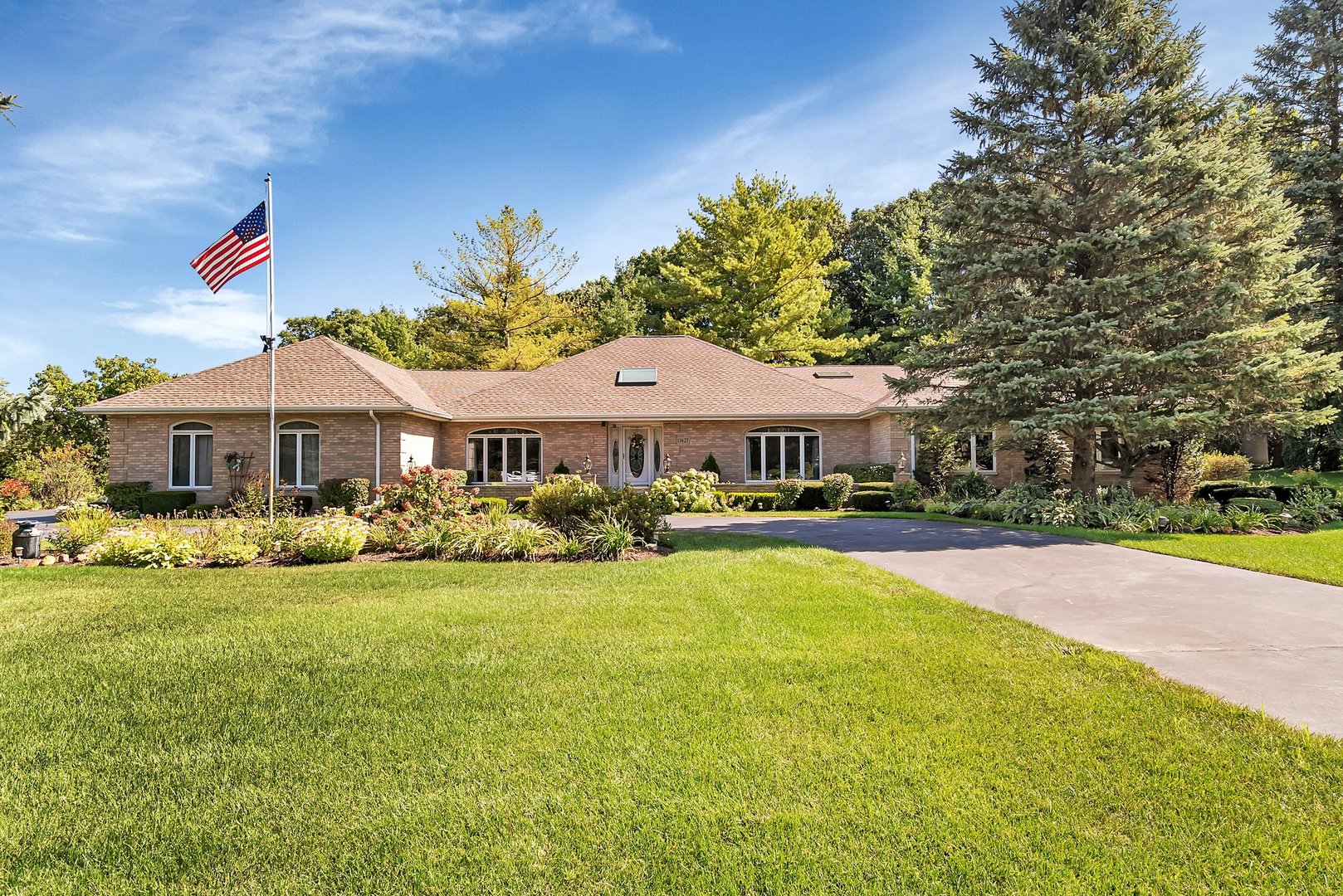 a front view of a house with a garden and porch