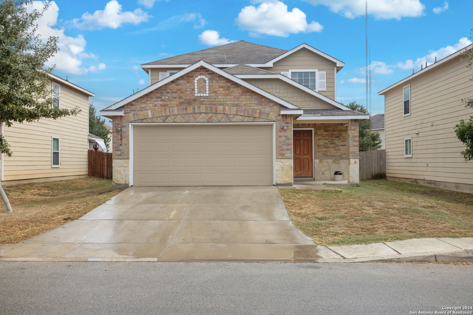 a front view of a house with a yard and garage