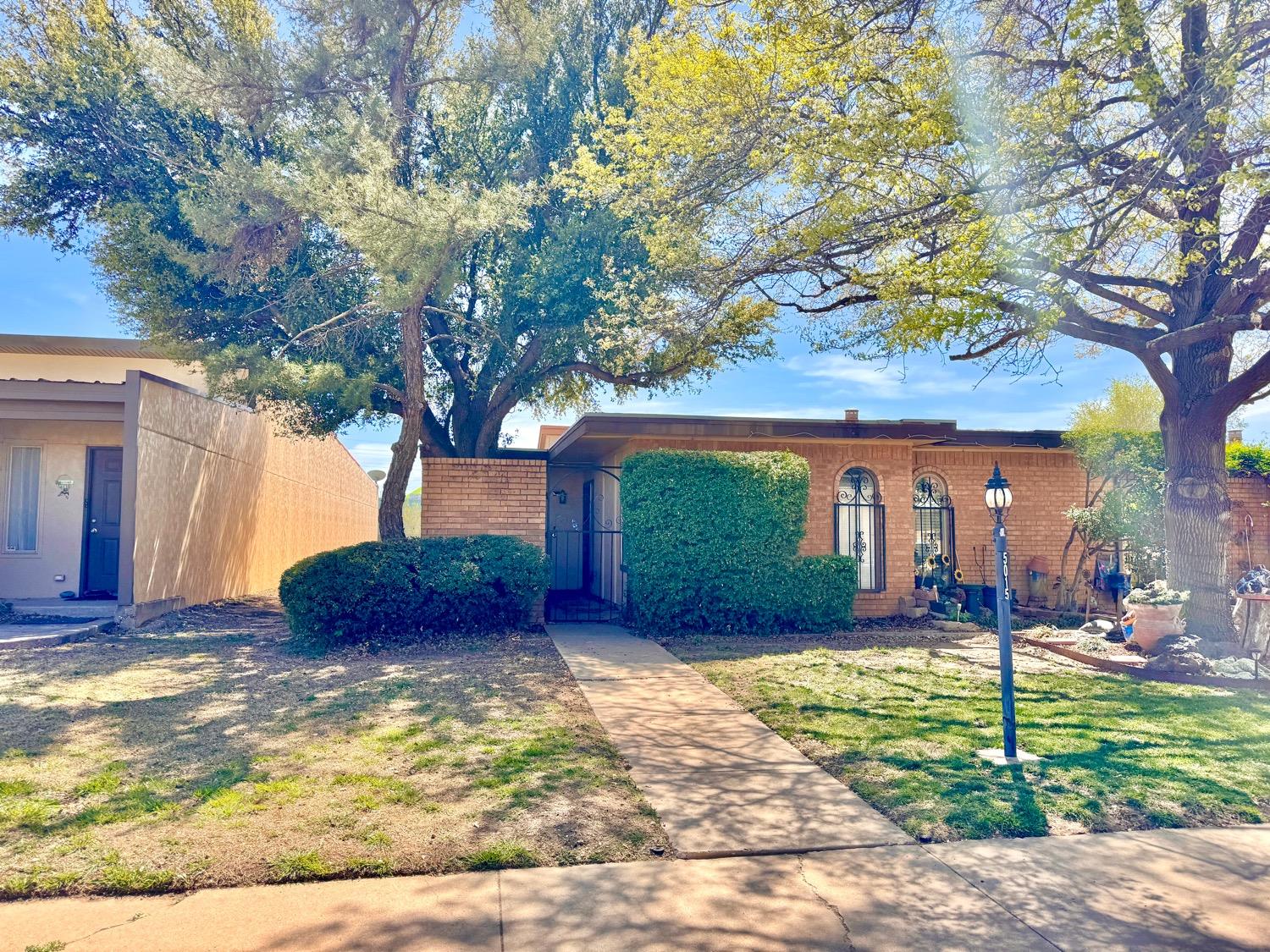 a view of a house with backyard and a tree