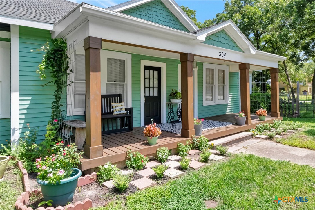 a front view of a house with an outdoor seating