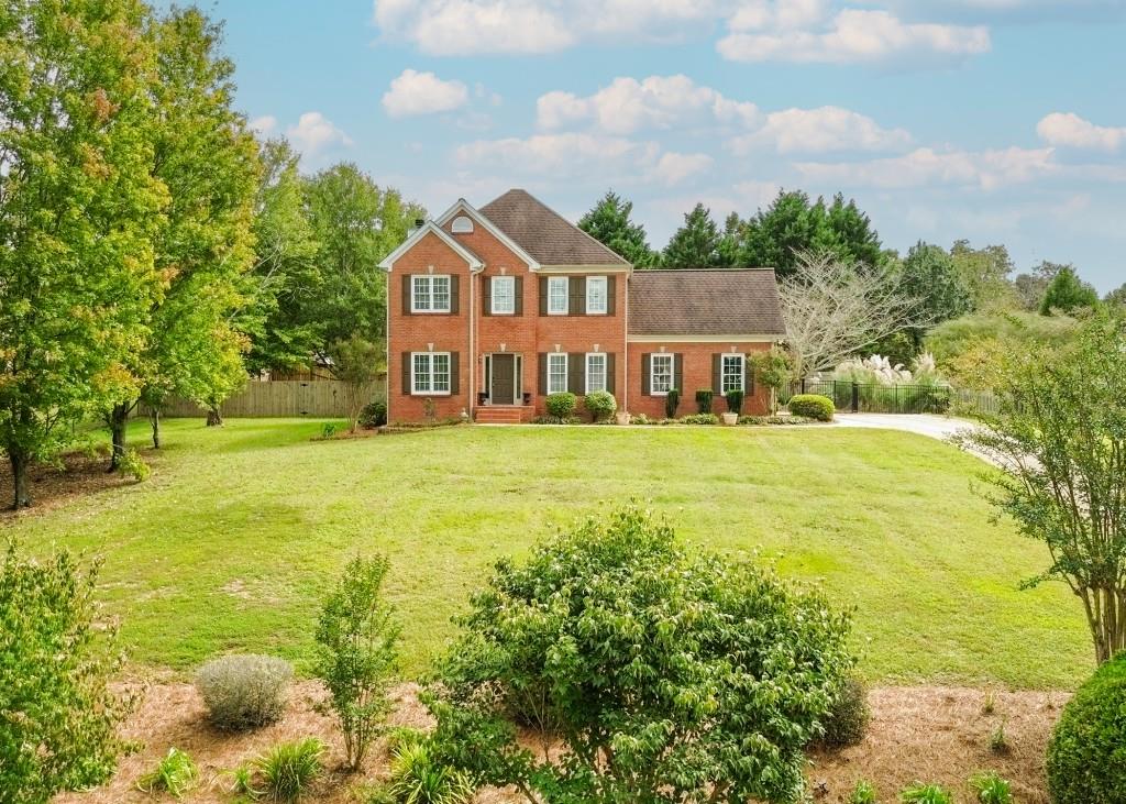 a front view of a house with a yard