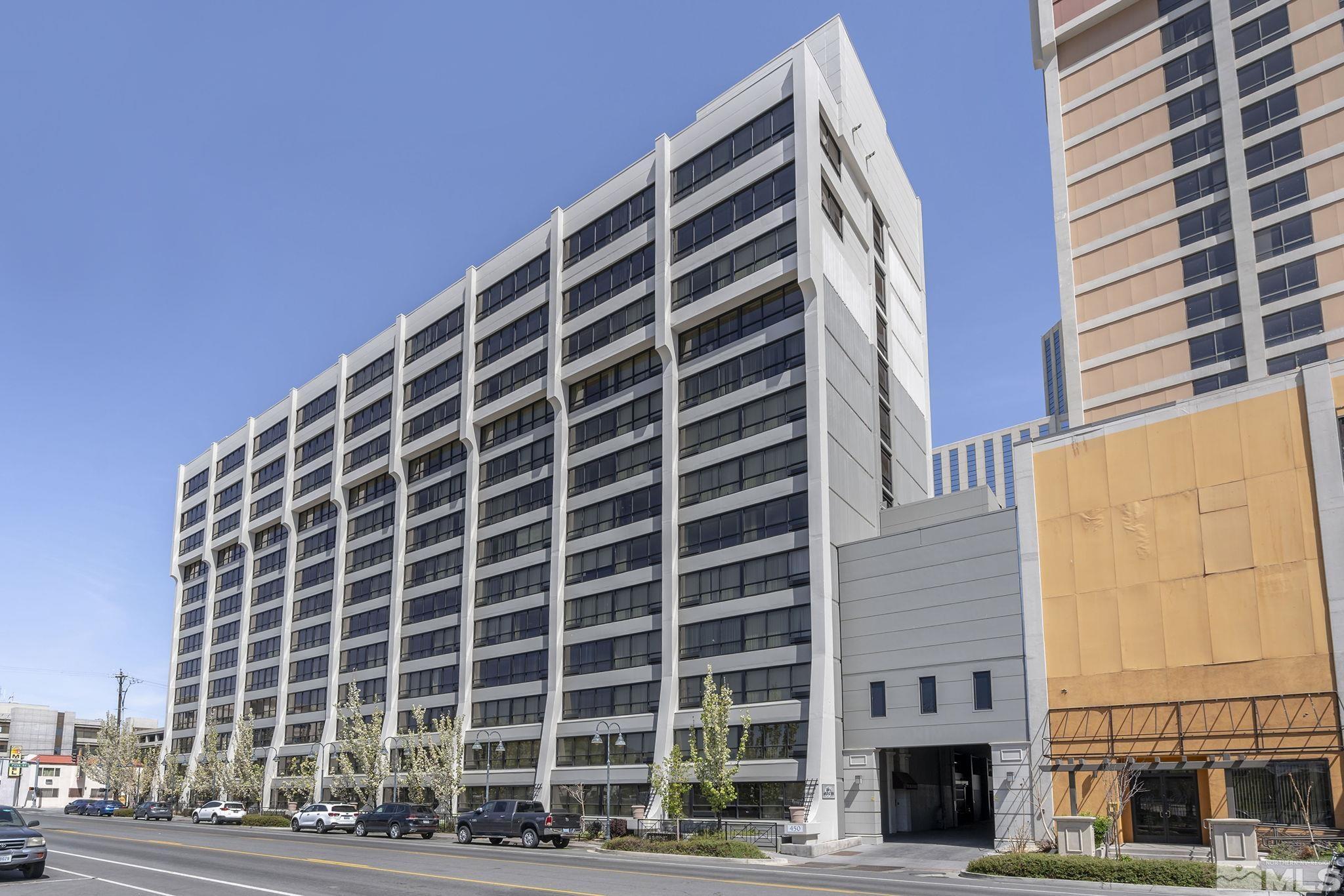 a view of tall building with a yard