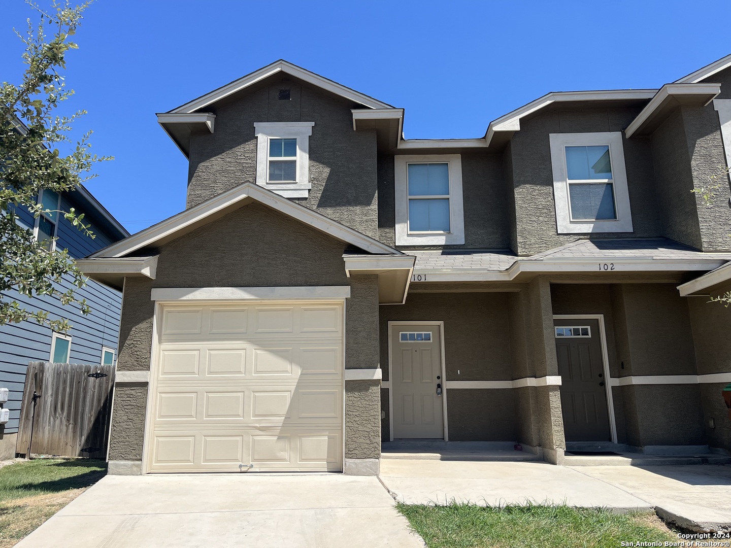 a front view of a house with garage