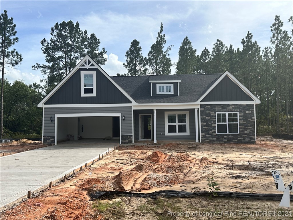 a front view of a house with a garden and trees