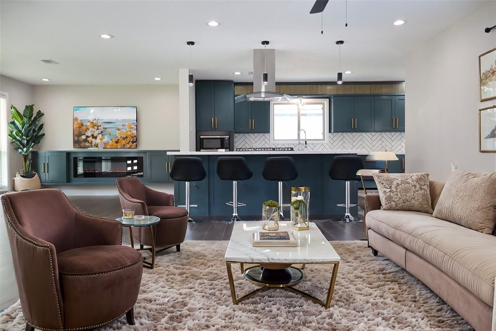 a living room with furniture kitchen view and a fireplace