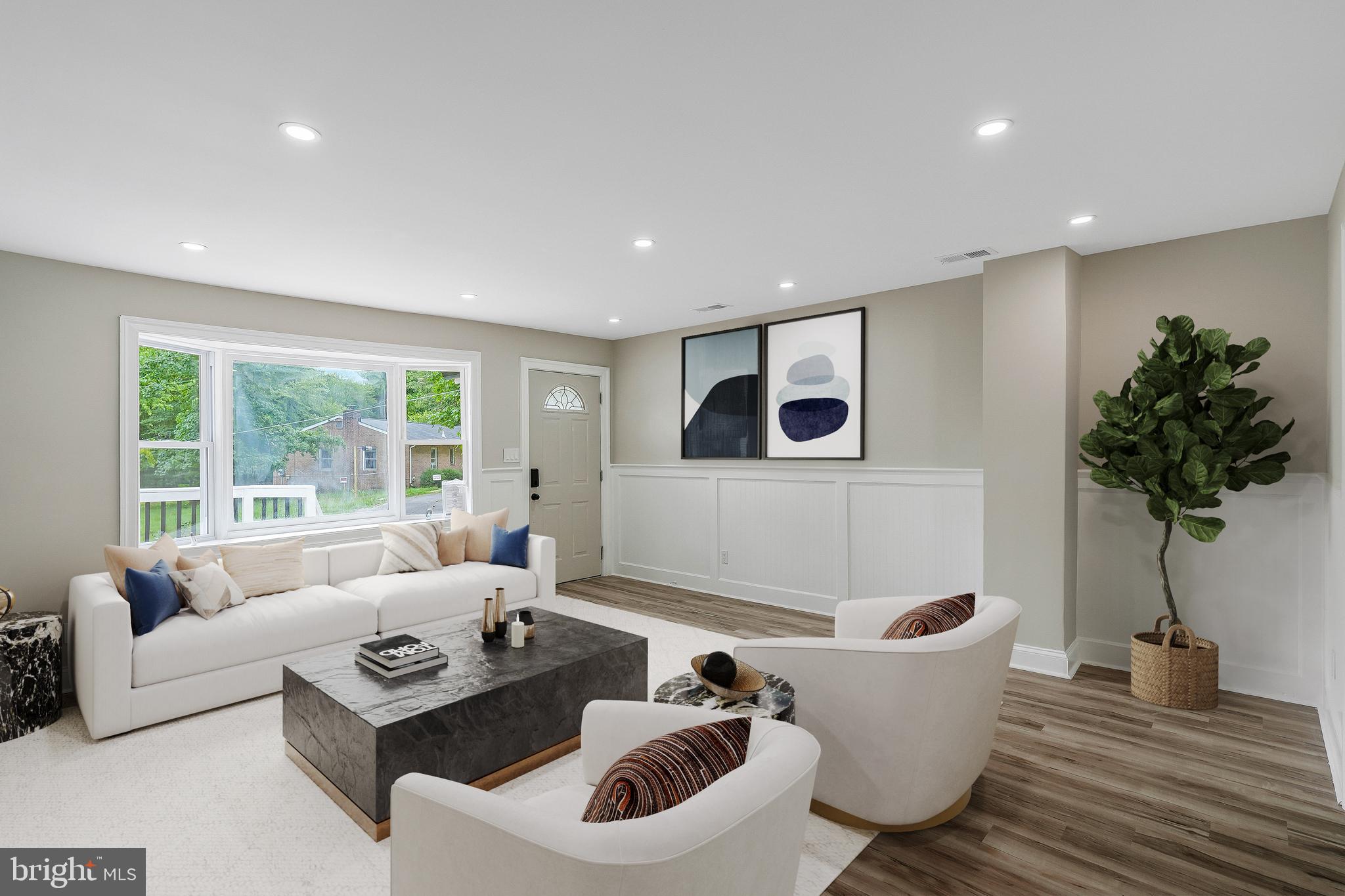 a living room with furniture and a potted plant