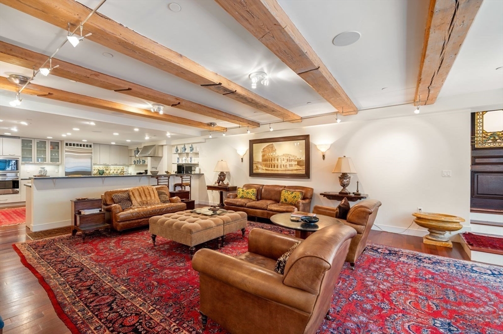 a living room with furniture a rug and a chandelier