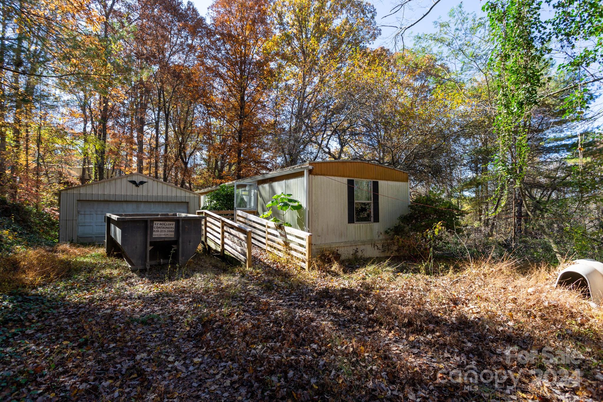 a view of a house with a yard and hanging chair