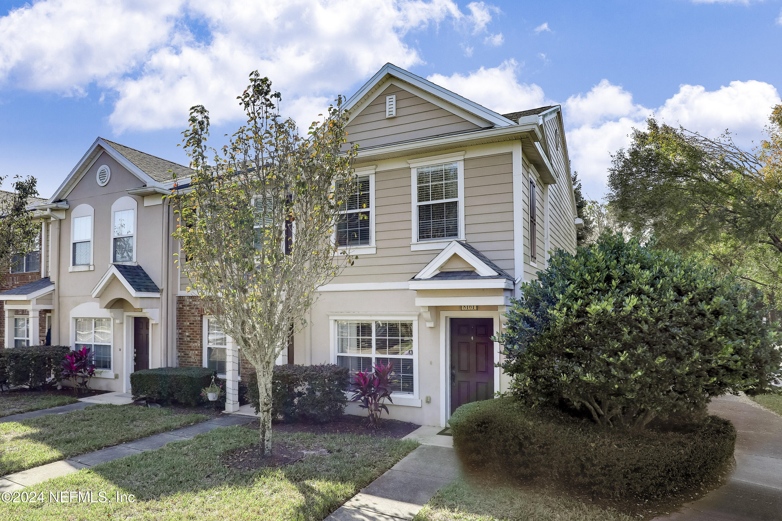 a front view of a house with a yard garage and outdoor seating