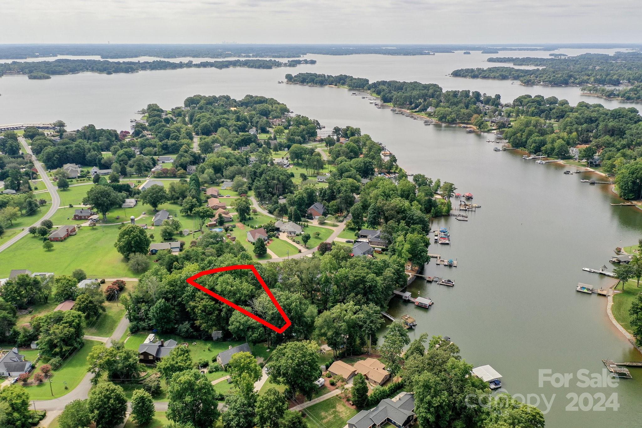 a view of a lake with a house and outdoor space