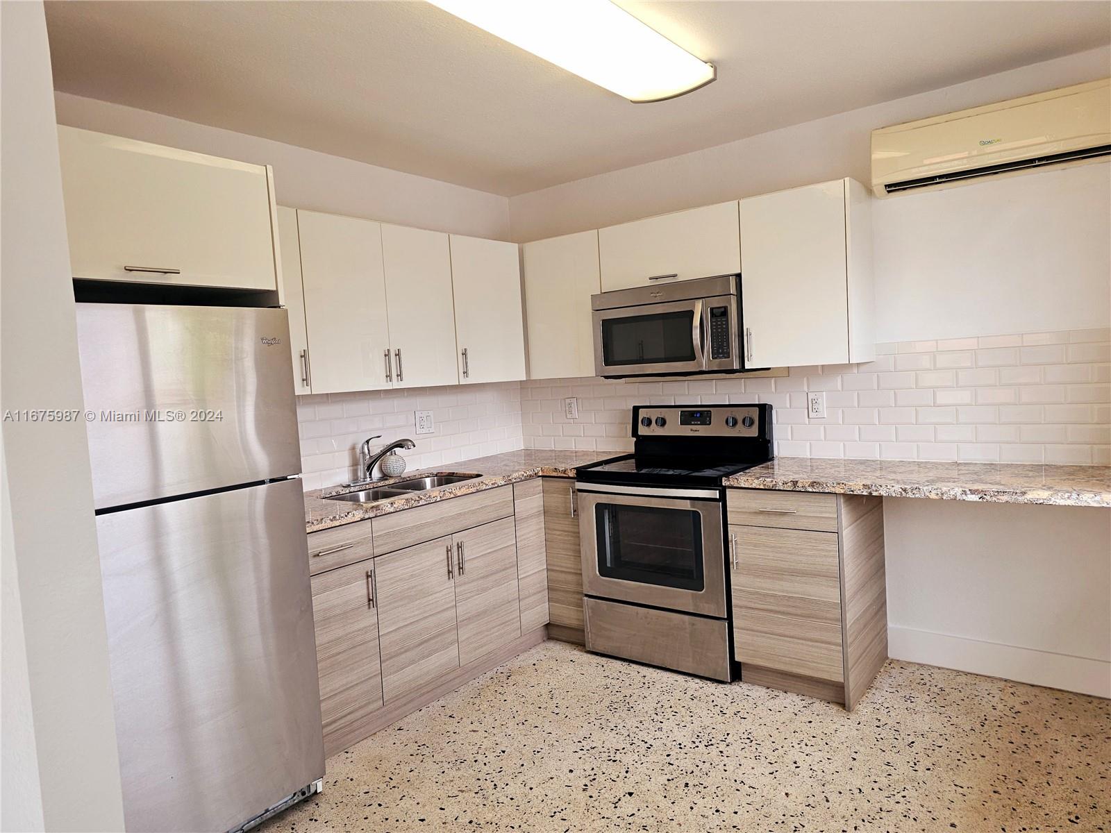 a kitchen with a refrigerator stove and microwave