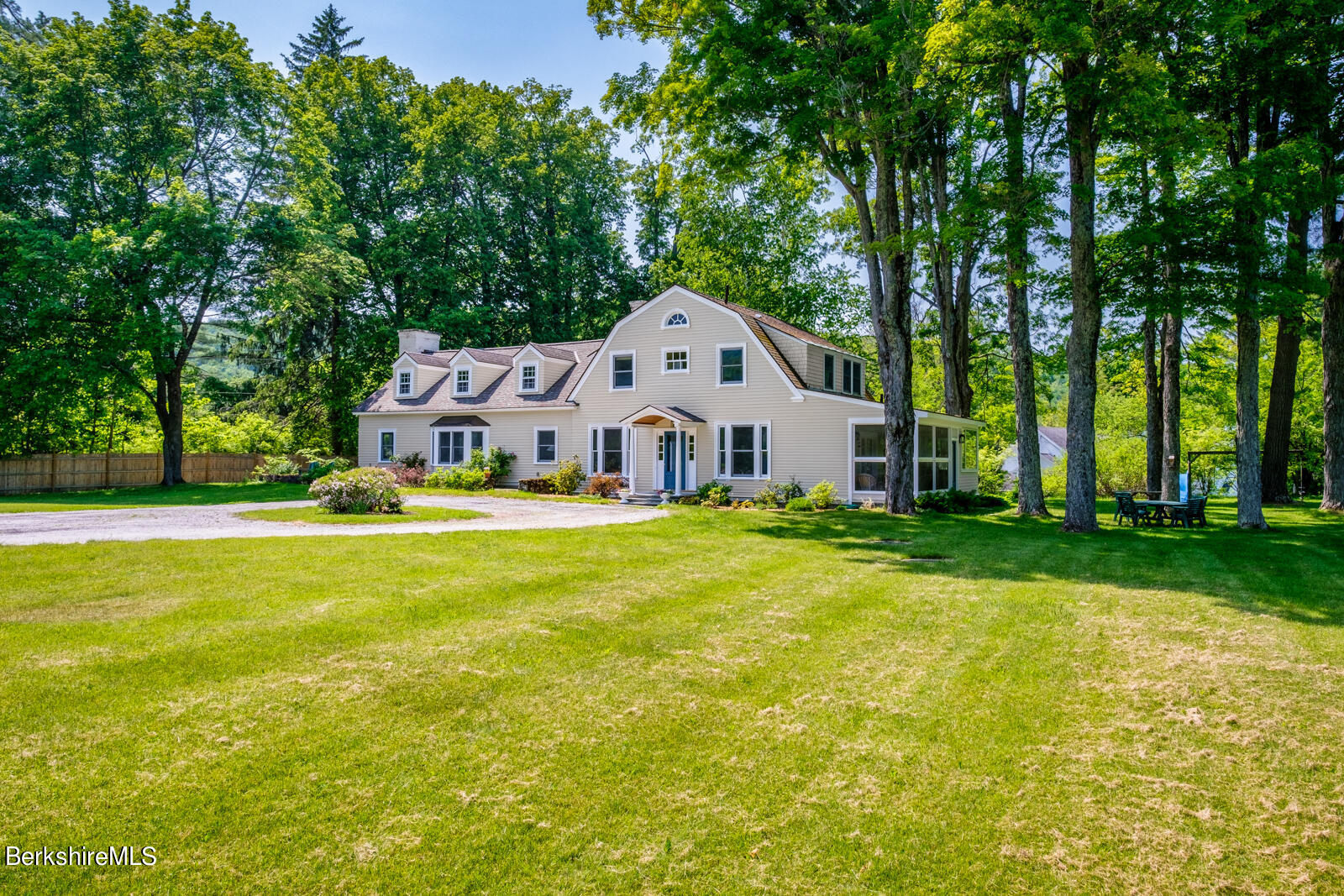 a house view with swimming pool in front of it