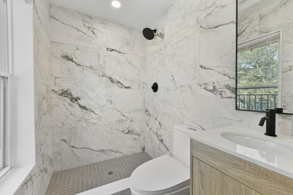 a bathroom with a sink toilet and shower