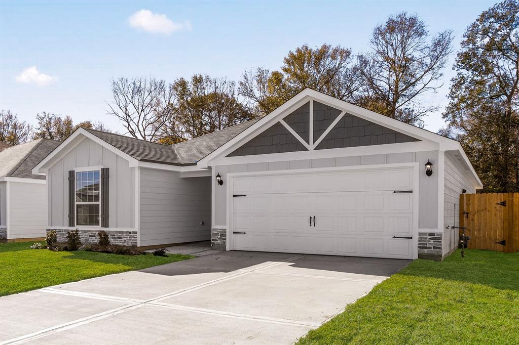 a view of a white house with a yard and garage