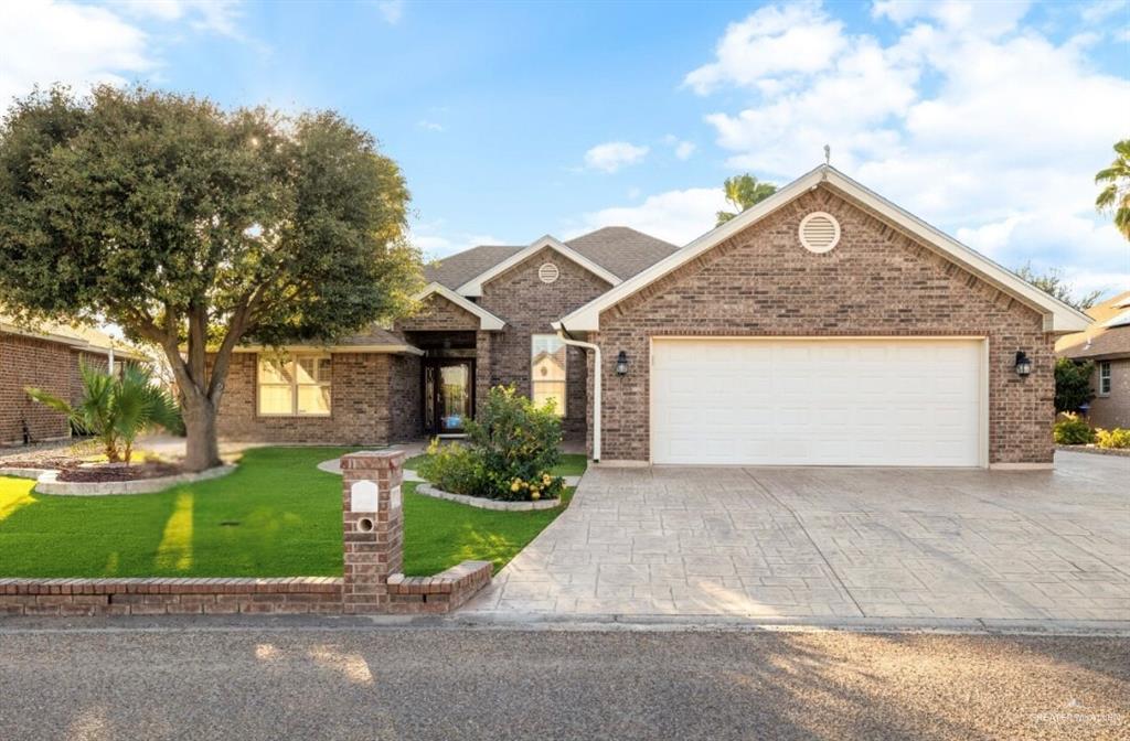 View of front of home featuring a garage and a front lawn