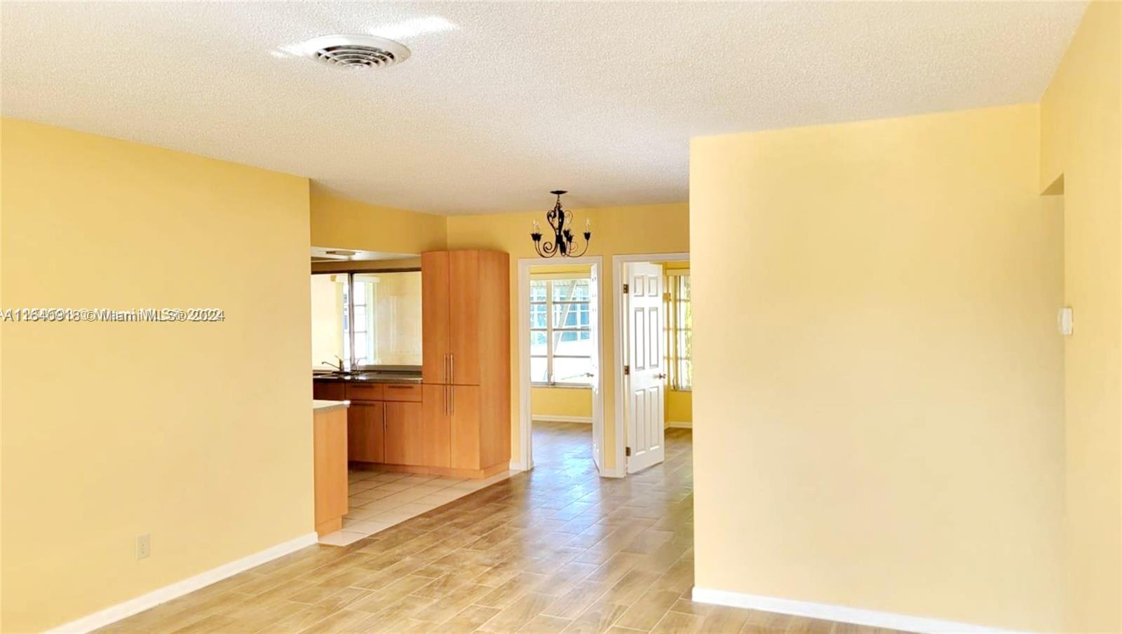 a view of a kitchen interior of the house and wooden floor