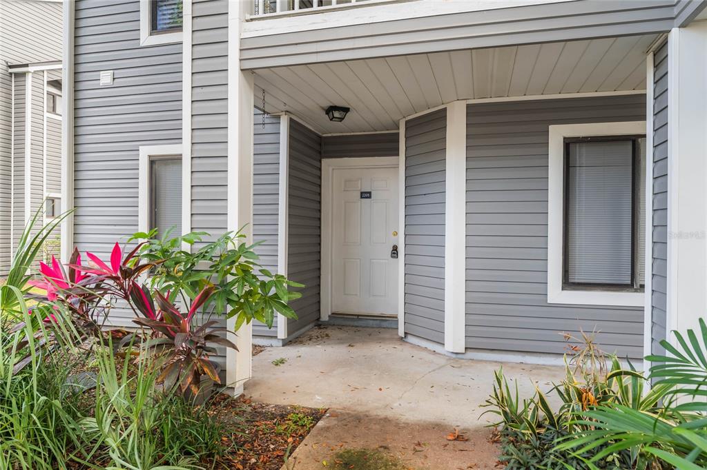 a front view of a house with plants