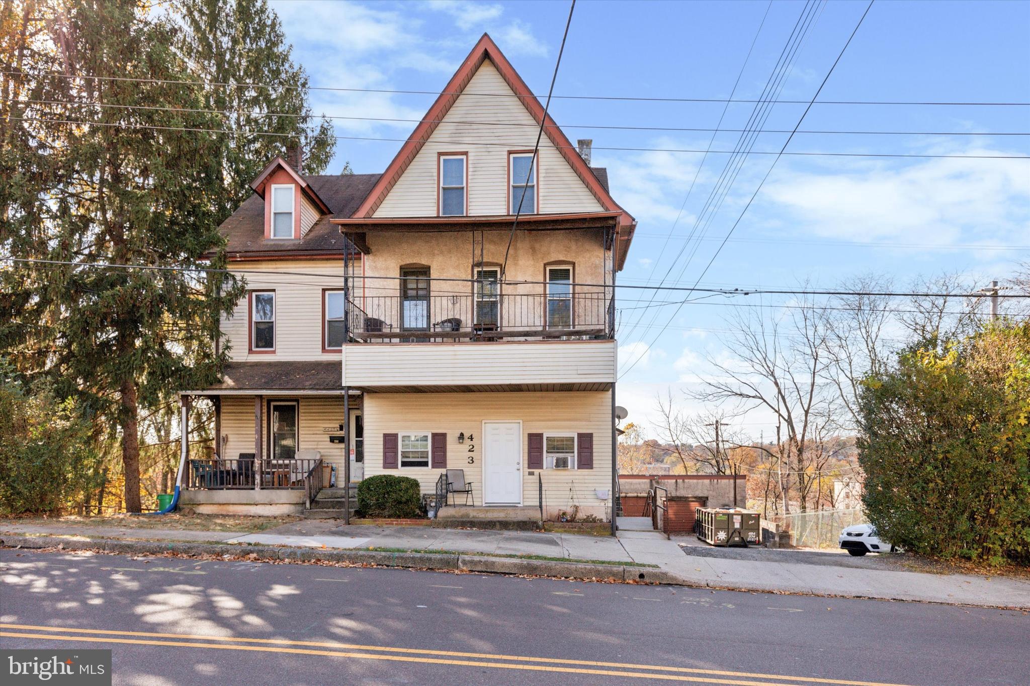 a front view of a residential apartment building with a yard