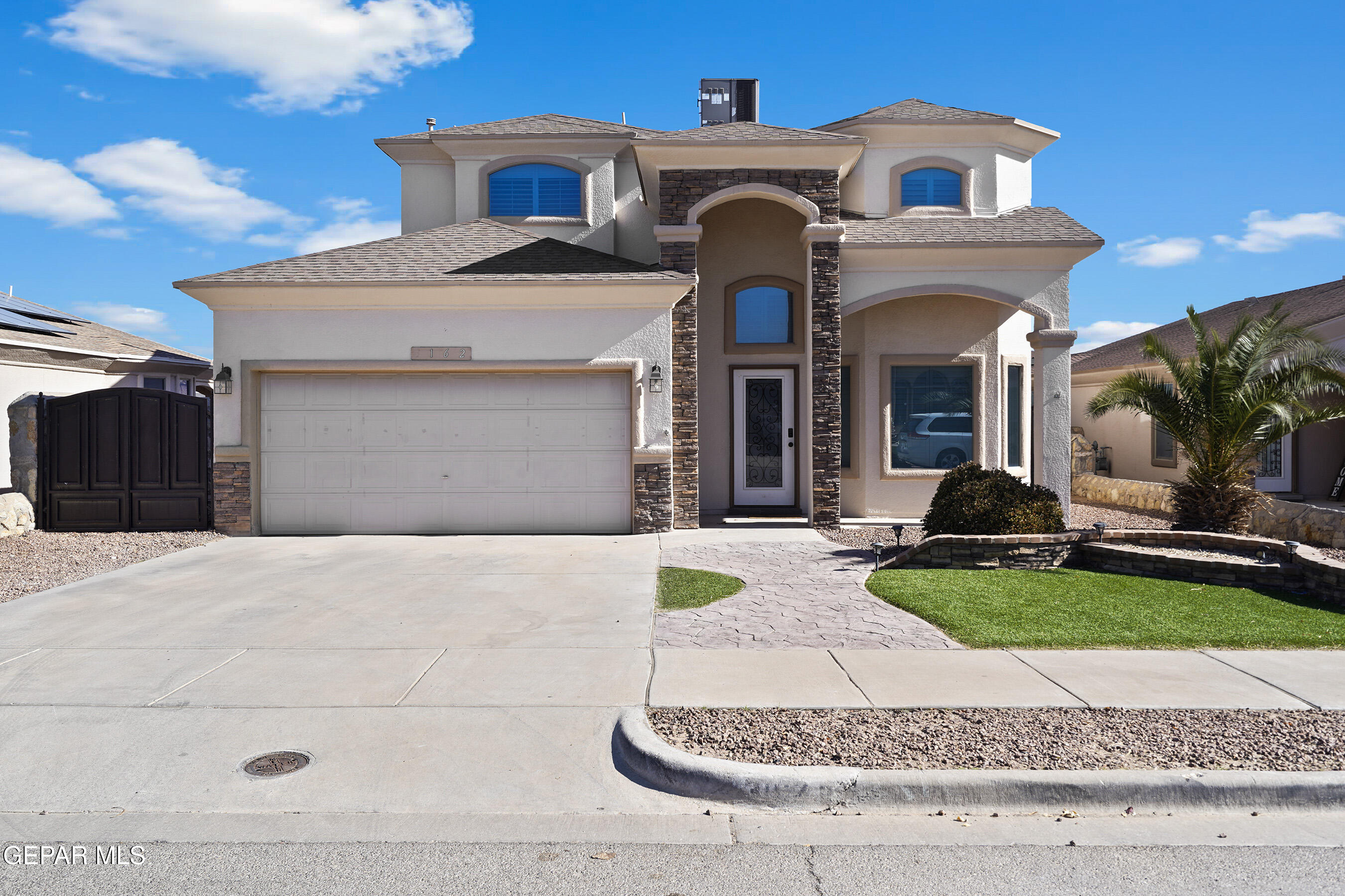 a view of a brick house with a yard