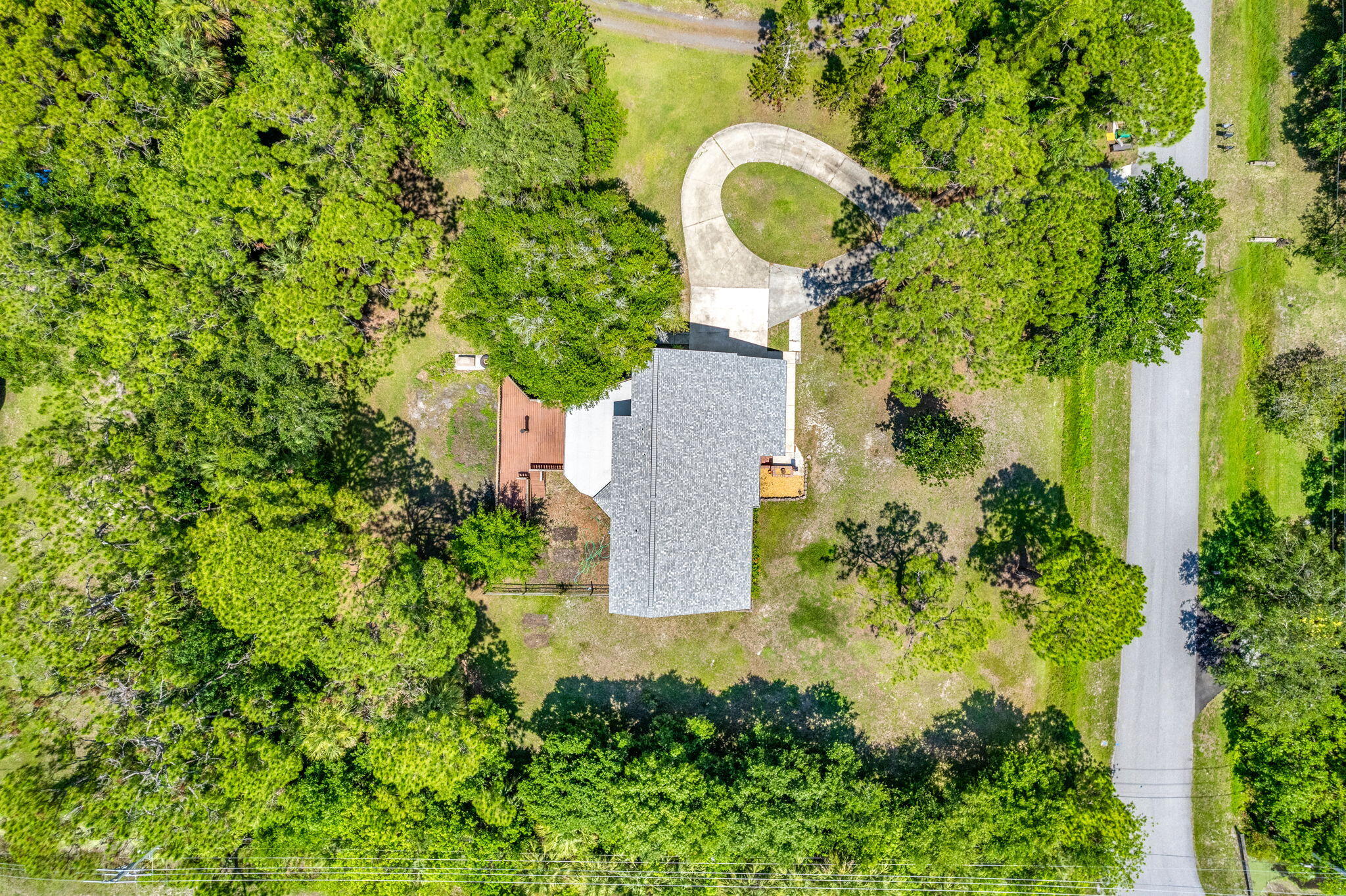 an aerial view of a house with a yard and garden