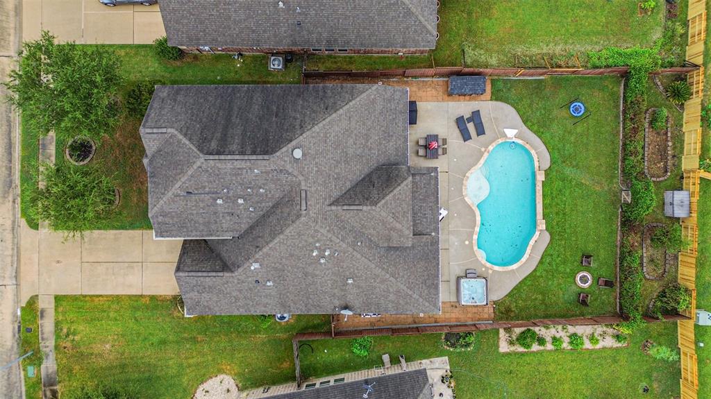 an aerial view of a house with a swimming pool