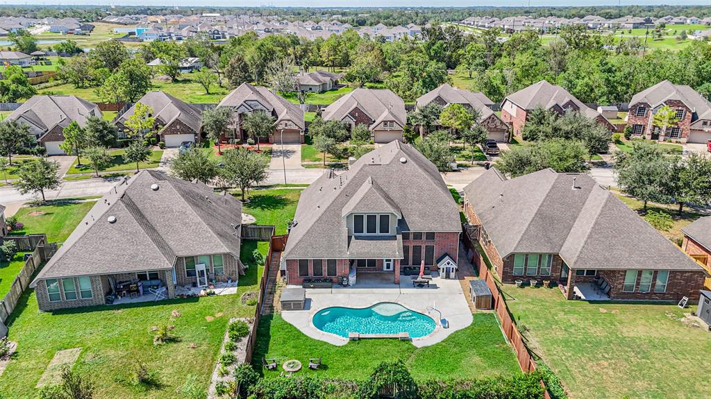 an aerial view of a house with swimming pool garden and patio