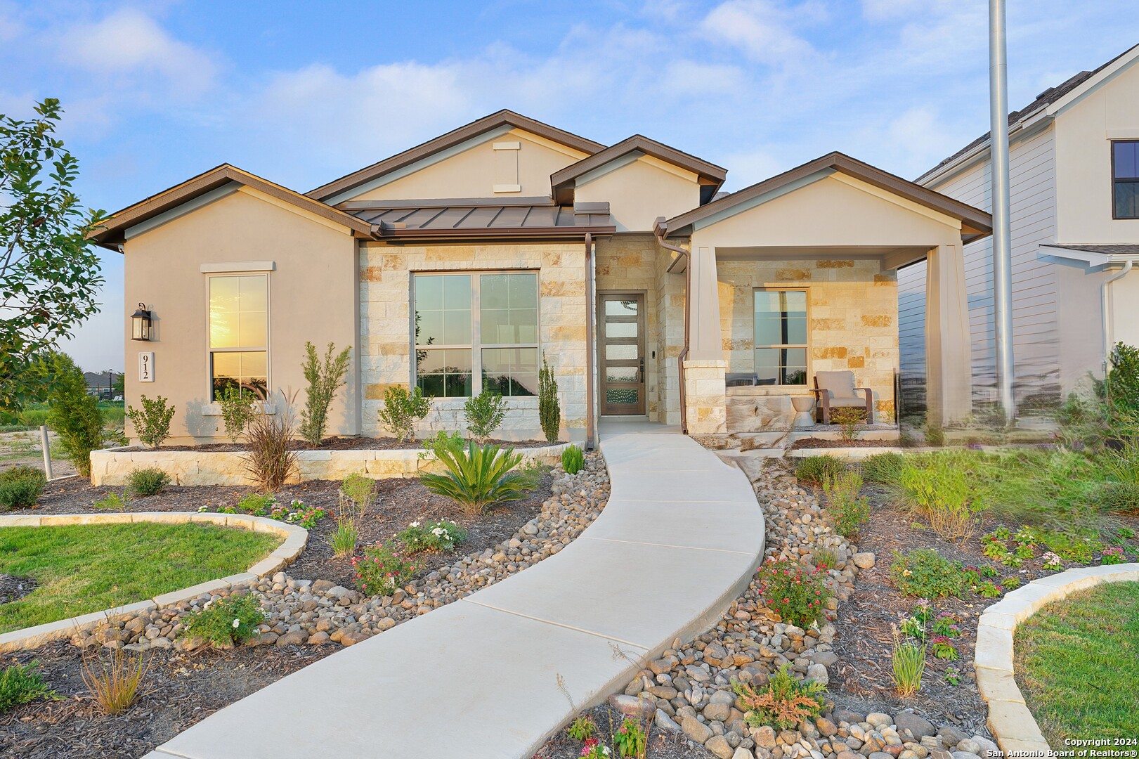 a front view of a house with garden