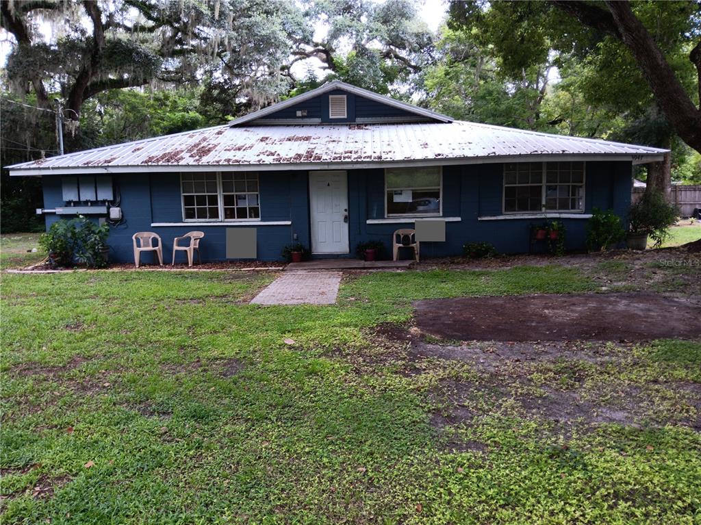 a view of a house with a yard porch and sitting area