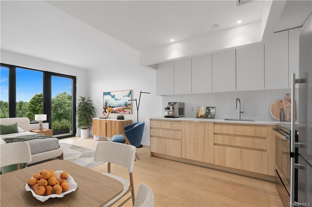 a kitchen with furniture and a large window