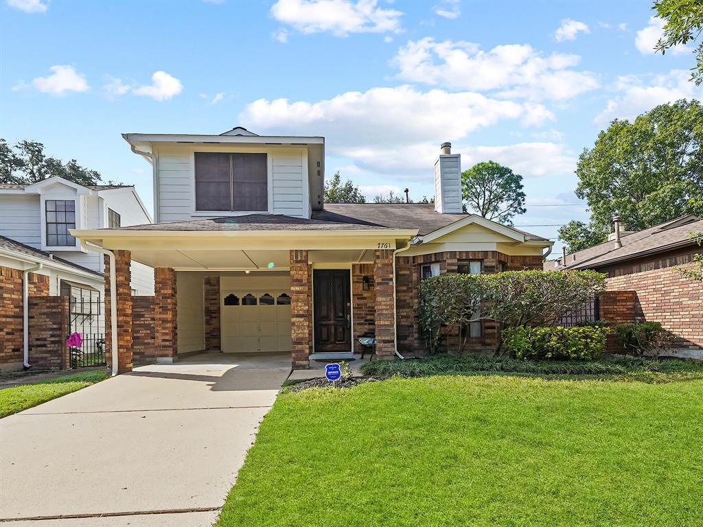 a front view of a house with a yard and potted plants