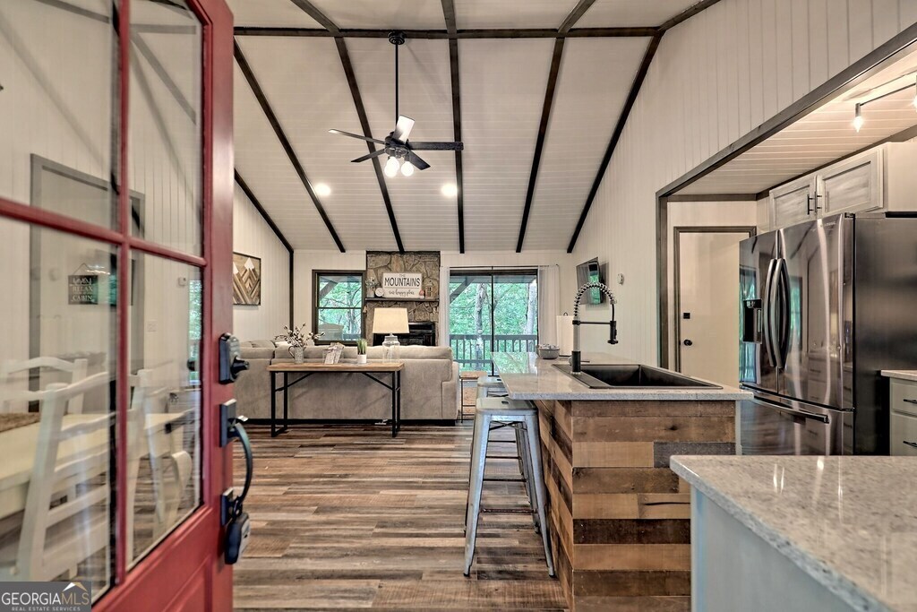 a dining hall with couches and wooden floor