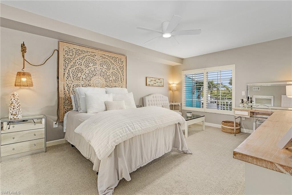 a bedroom with a large bed and a large window